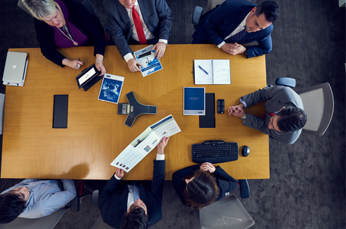 A group of people sit around a table and talk