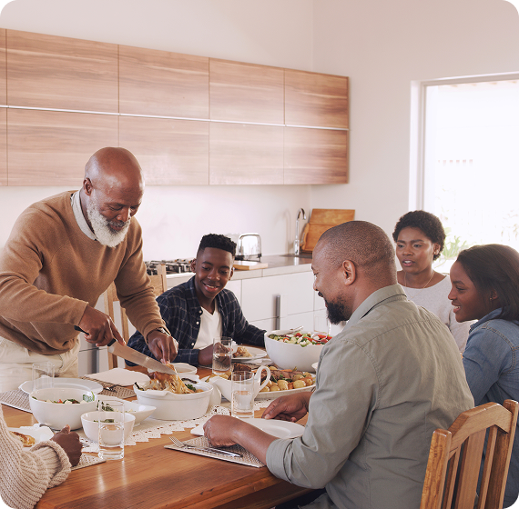 Image of a family sharing a meal together around a dining table.