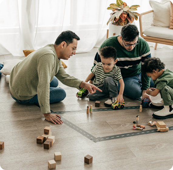 Image of family playing together on the floor with wooden toys