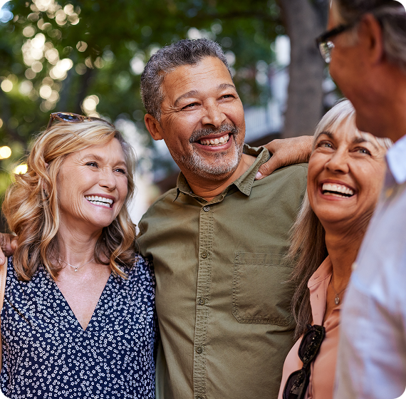 Image of group of friends smiling and laughing together outdoors.