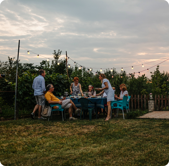  Image of family and friends gathered outdoors at sunset.