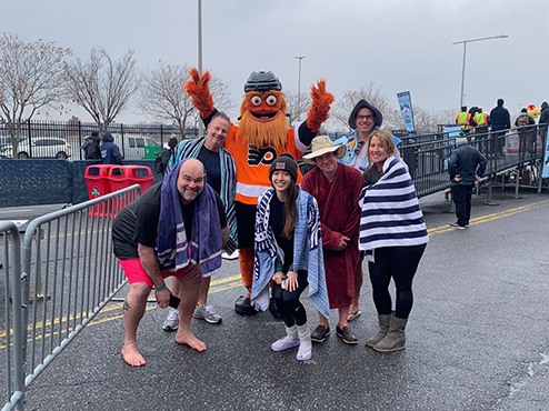 Janney employees posing for picture following participation in Polar Plunge event