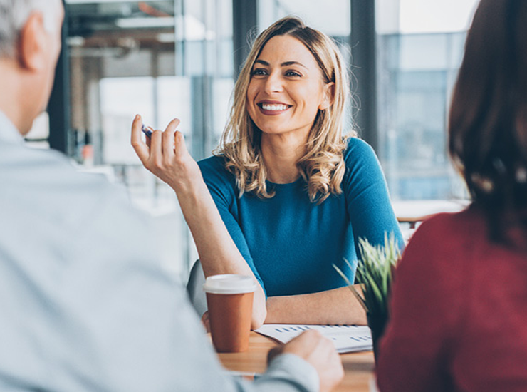 Three people discuss ideas.