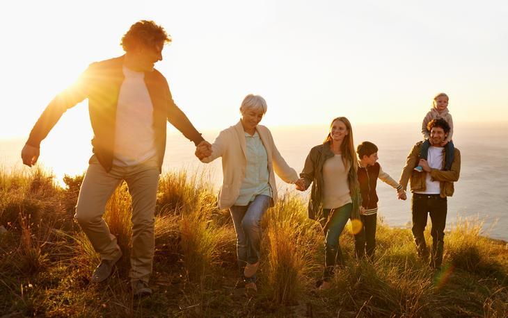 A family walks up a hill together.