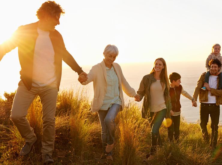 A family walks up a hill together.